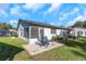 Spacious backyard featuring a cozy patio and lush green grass at 3806 River Oaks Ct, New Port Richey, FL 34655