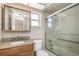 Cozy bathroom with a vanity, medicine cabinet, and glass-enclosed shower at 3806 River Oaks Ct, New Port Richey, FL 34655
