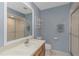 Cozy bathroom with large mirror, shower, and vanity with under-cabinet storage at 3806 River Oaks Ct, New Port Richey, FL 34655