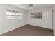 Bedroom featuring carpeted flooring, natural light and a white ceiling fan at 3806 River Oaks Ct, New Port Richey, FL 34655