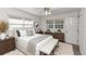 Cozy bedroom with large windows, a comfortable bed, and a neutral color scheme at 3806 River Oaks Ct, New Port Richey, FL 34655