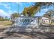 Stone sign identifying the River Oaks community with a water feature and lush landscaping at 3806 River Oaks Ct, New Port Richey, FL 34655