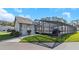 Exterior of a charming home with a screened-in pool, showcasing outdoor living at its finest at 3806 River Oaks Ct, New Port Richey, FL 34655