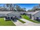 Exterior shot of a well-maintained house, showcasing driveway, two-car garage, and landscaping at 3806 River Oaks Ct, New Port Richey, FL 34655