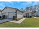 Charming single-story home with an attached garage, manicured lawn, and fresh landscaping at 3806 River Oaks Ct, New Port Richey, FL 34655