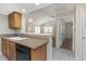 Open kitchen area with a breakfast bar overlooking the living space, complete with tile flooring at 3806 River Oaks Ct, New Port Richey, FL 34655