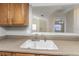 A close-up of the kitchen sink with counter space, offering a view into the living area at 3806 River Oaks Ct, New Port Richey, FL 34655