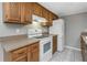 Close-up of the kitchen showcasing oak cabinets, a white range, and a white refrigerator at 3806 River Oaks Ct, New Port Richey, FL 34655