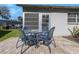 Brick patio featuring table with four chairs and a nice view of backyard landscaping and pool at 3806 River Oaks Ct, New Port Richey, FL 34655
