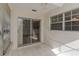 Sun room with tile floors, natural light and a view of the backyard through a sliding door at 3806 River Oaks Ct, New Port Richey, FL 34655