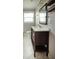 Bathroom with dark vanity, white countertops, and square mirror at 4009 N Seminole Ave, Tampa, FL 33603