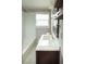 Bathroom vanity with dark wood and white marble-like floors at 4009 N Seminole Ave, Tampa, FL 33603
