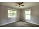 Cozy bedroom featuring a ceiling fan and dual windows, providing plenty of natural light at 4009 N Seminole Ave, Tampa, FL 33603