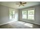 Bedroom with three windows, ceiling fan and light grey walls at 4009 N Seminole Ave, Tampa, FL 33603