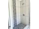 Walk-in shower with stone tile and textured ceramic tiling at 4009 N Seminole Ave, Tampa, FL 33603