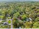 Aerial view of a charming house nestled amongst a canopy of lush, green trees at 406 Zoller St, Brooksville, FL 34601