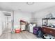 A partially cluttered basement space with gray walls and light-colored flooring at 406 Zoller St, Brooksville, FL 34601