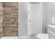 Clean bathroom featuring wood-look tile, white fixtures, and ample lighting at 406 Zoller St, Brooksville, FL 34601