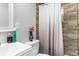 Well-lit bathroom featuring wood-look tile in shower, white fixtures, and neutral decor at 406 Zoller St, Brooksville, FL 34601