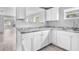 Bright kitchen featuring white cabinets, gray countertops, and stainless steel sink and faucet at 406 Zoller St, Brooksville, FL 34601