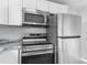 Stainless steel appliances adorn this kitchen, including a range, microwave, and refrigerator at 406 Zoller St, Brooksville, FL 34601