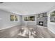 Bright living room featuring wood-look floors, a decorative fireplace and lots of natural light at 406 Zoller St, Brooksville, FL 34601