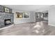 Bright, open living room featuring a stone fireplace, light wood floors, and large windows for natural light at 406 Zoller St, Brooksville, FL 34601