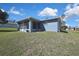 The backyard features a well-maintained lawn, screened patio, and mature landscaping at 4206 Candler Ave, Spring Hill, FL 34609