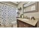 Cozy bathroom showcasing granite countertop, vanity, and dinosaur shower curtain at 4206 Candler Ave, Spring Hill, FL 34609