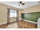 Bright bedroom with ample natural light, neutral walls, and wood-look floors at 4206 Candler Ave, Spring Hill, FL 34609