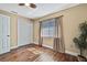 Bedroom featuring wood-look floors, natural light and a double door closet at 4206 Candler Ave, Spring Hill, FL 34609