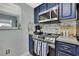 A kitchen area with a stainless steel range and microwave, and modern countertops at 4206 Candler Ave, Spring Hill, FL 34609