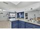A kitchen area with a marble-styled island, stainless steel appliances, and a view of the living room at 4206 Candler Ave, Spring Hill, FL 34609