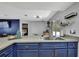 A kitchen area with a marble-styled island, stainless steel appliances, and a view of the living room at 4206 Candler Ave, Spring Hill, FL 34609