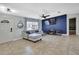 Bright living room featuring tile floors, and a decorative blue accent wall with large screen TV at 4206 Candler Ave, Spring Hill, FL 34609