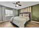 Relaxing main bedroom featuring plush bedding, a ceiling fan, and soft natural light at 4206 Candler Ave, Spring Hill, FL 34609