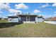 A nice view of the property's back screened in lanai and expansive yard at 4206 Candler Ave, Spring Hill, FL 34609