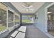 Relaxing screened-in patio features a ceiling fan and views of the backyard at 4206 Candler Ave, Spring Hill, FL 34609
