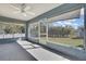 This sunroom has lots of natural light, a ceiling fan, and access to a large, fenced backyard at 4206 Candler Ave, Spring Hill, FL 34609