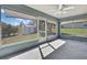 This bright sunroom features plenty of windows and a ceiling fan to keep you comfortable year-round at 4206 Candler Ave, Spring Hill, FL 34609