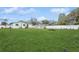 Expansive green backyard featuring a white fence and mature trees, providing a private outdoor retreat at 4544 Cynthia Ln, Spring Hill, FL 34606