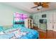 Comfortable bedroom with a ceiling fan and a vibrant accent window at 4544 Cynthia Ln, Spring Hill, FL 34606