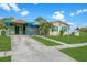 Exterior of a cozy home featuring vibrant colors, a carport, and a well-manicured lawn at 4544 Cynthia Ln, Spring Hill, FL 34606