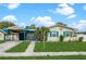 Charming home with vibrant exterior colors, a carport, and a well-kept lawn at 4544 Cynthia Ln, Spring Hill, FL 34606