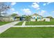 Quaint home with colorful accents, a large front yard, and inviting curb appeal at 4544 Cynthia Ln, Spring Hill, FL 34606