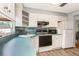 Well-lit kitchen with a sleek countertop, white cabinets, and modern appliances at 4544 Cynthia Ln, Spring Hill, FL 34606