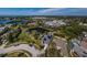 Expansive aerial view of a neighborhood with lake views and solar panels on the roof at 494 Village Dr, Tarpon Springs, FL 34689