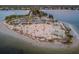 Aerial view of a beach featuring palm trees, a shelter, people, and scenic views of surrounding waters at 494 Village Dr, Tarpon Springs, FL 34689