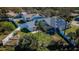 A lush backyard features a covered patio, and solar panels above at 494 Village Dr, Tarpon Springs, FL 34689