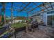 Backyard featuring a vine-covered pergola, concrete patio, raised garden beds, and a view of the home at 494 Village Dr, Tarpon Springs, FL 34689